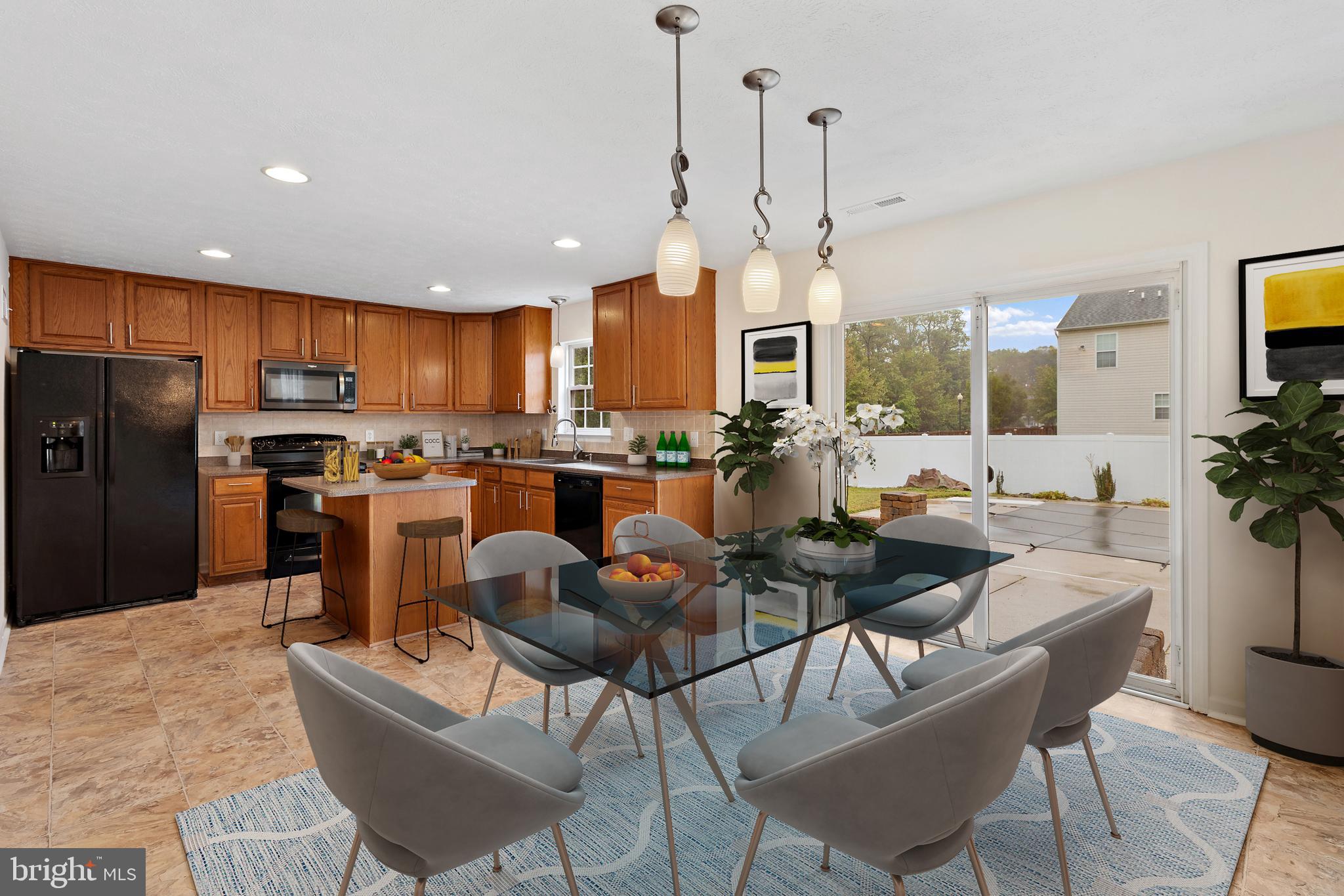 1612 Cattail Commons Way Denton, MD 21629 - Photo 16 of 67 a large kitchen with a table and chairs