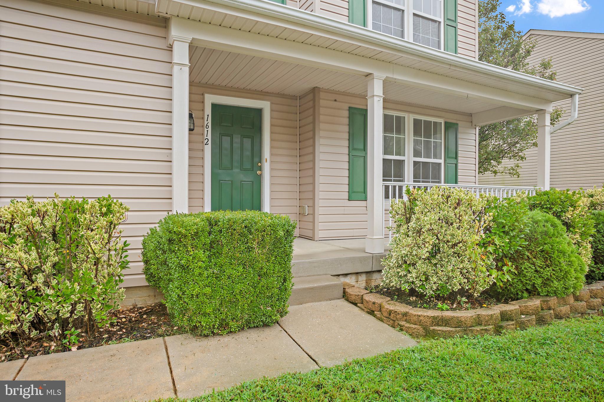 1612 Cattail Commons Way Denton, MD 21629 - Photo 2 of 67 front view of a house with a garden