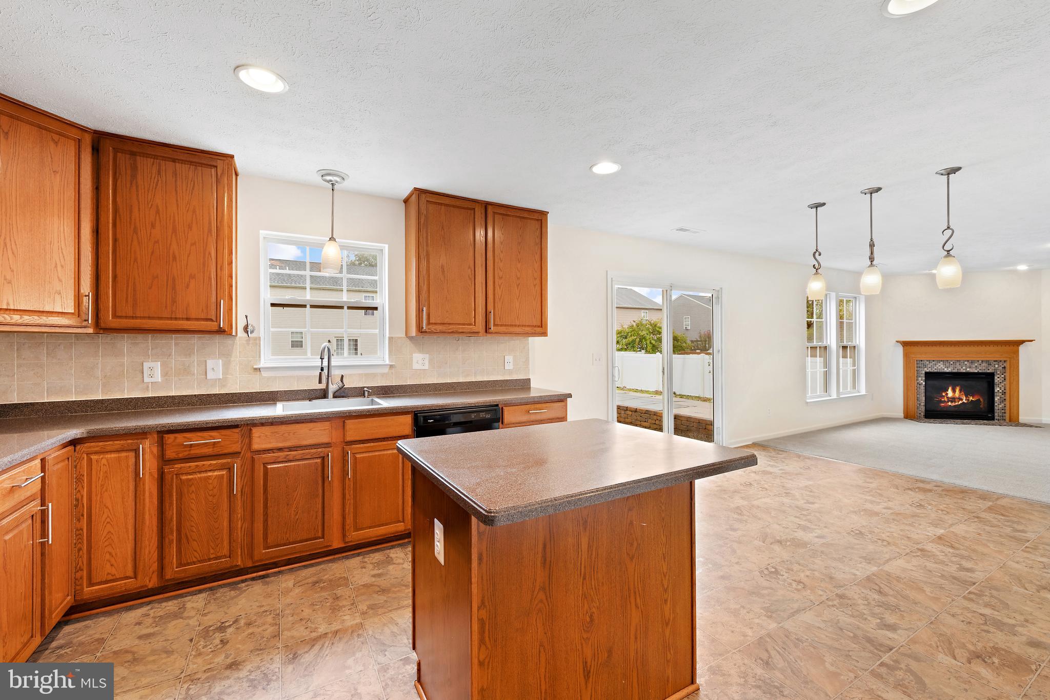 1612 Cattail Commons Way Denton, MD 21629 - Photo 24 of 67 a kitchen with stainless steel appliances granite countertop a sink stove and refrigerator