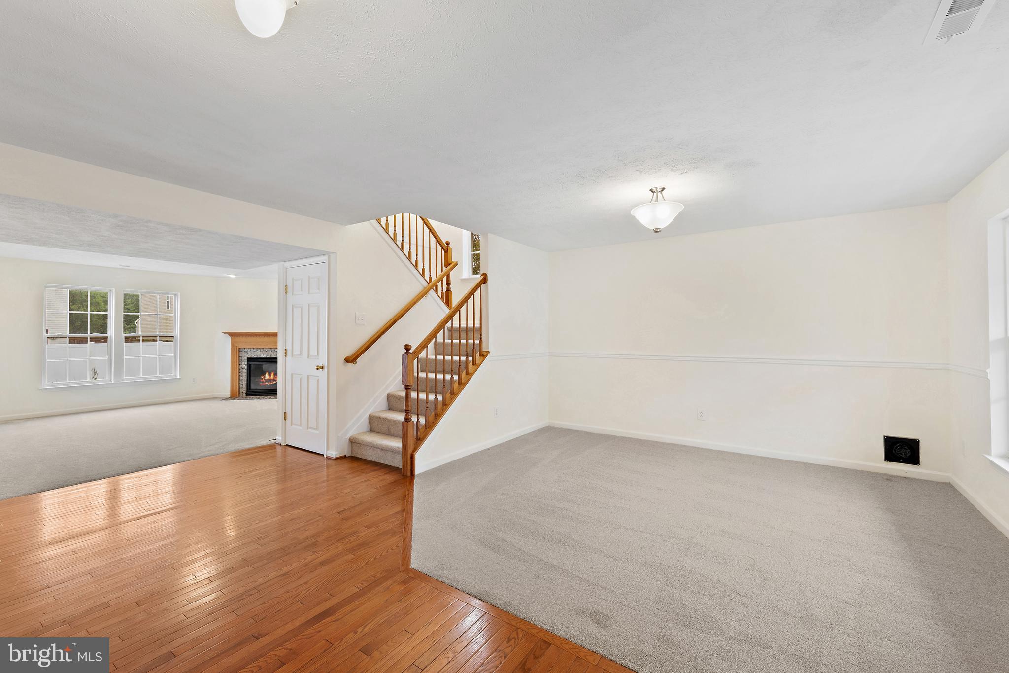 1612 Cattail Commons Way Denton, MD 21629 - Photo 4 of 67 a view of an empty room with wooden floor and a window
