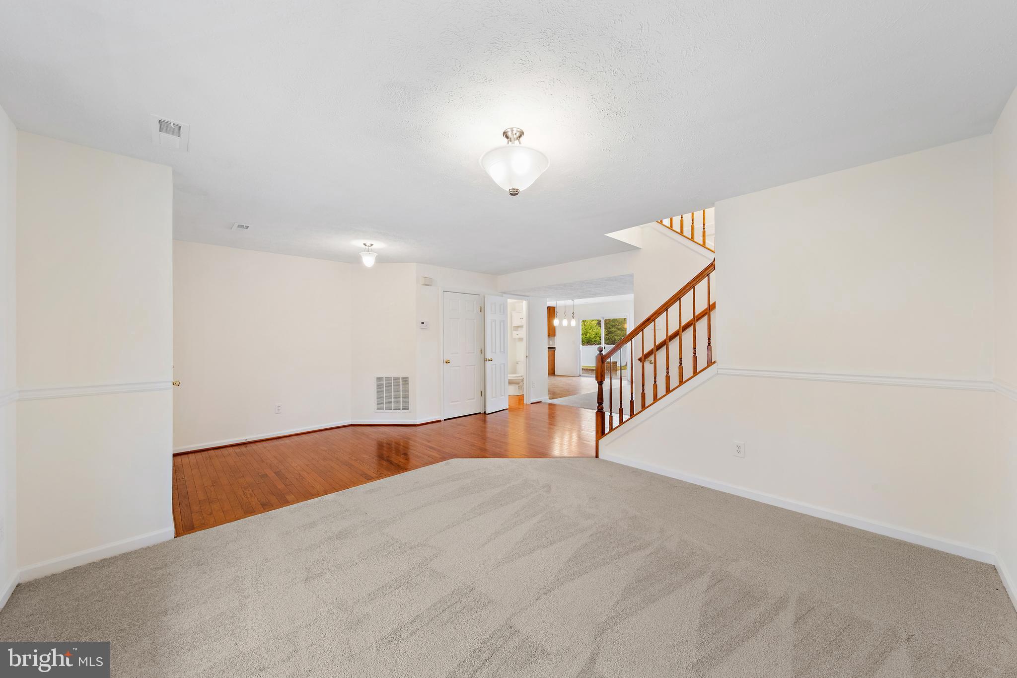 1612 Cattail Commons Way Denton, MD 21629 - Photo 6 of 67 a view of an empty room with wooden floor