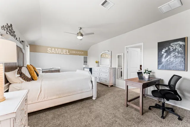 a bedroom with a bed a desk and chair