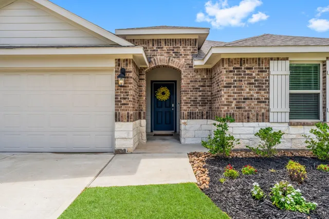 a front view of a house with a garden