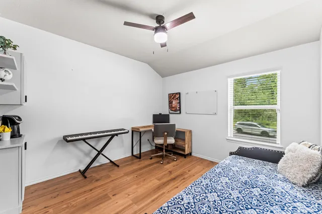 a bedroom with a bed window and a table