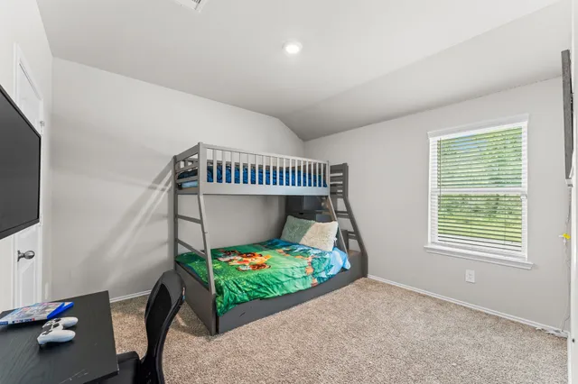 a bedroom with furniture and a window