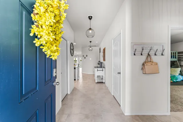 a view of a hallway with wooden floor and entryway