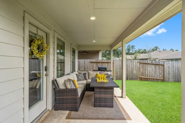 a balcony with furniture and a garden