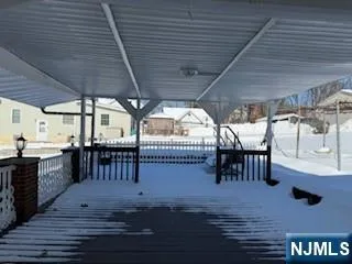 a view of a porch with furniture and a yard