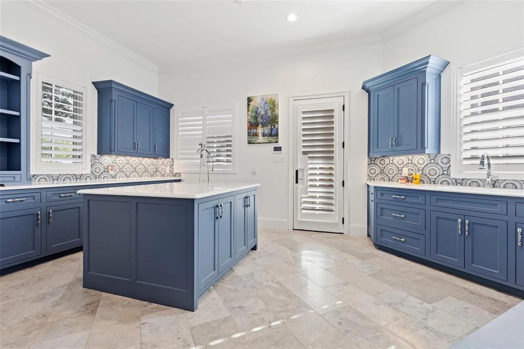 935 West Dove Road Southlake, TX 76092 - Photo 29 of 38 a kitchen with a sink and wooden cabinets