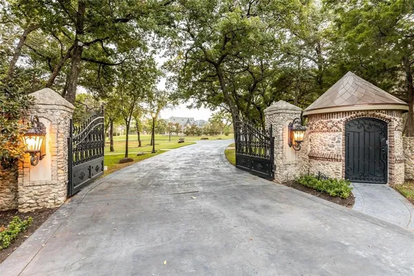 a view of a pathway with a wrought fence