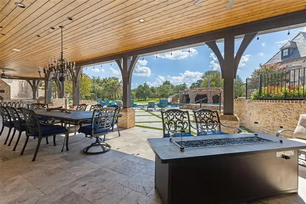 a view of a patio with a table chairs and backyard