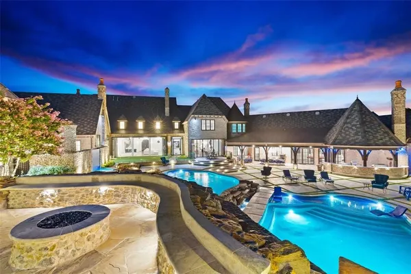 a view of a swimming pool with outdoor seating