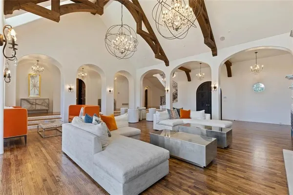 a living room with fireplace furniture and wooden floor