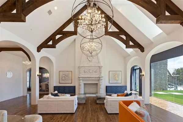 a living room with fireplace furniture and a large window