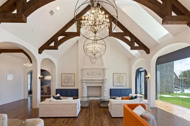 a living room with fireplace furniture and a large window