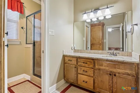 a bathroom with a sink toilet and a mirror