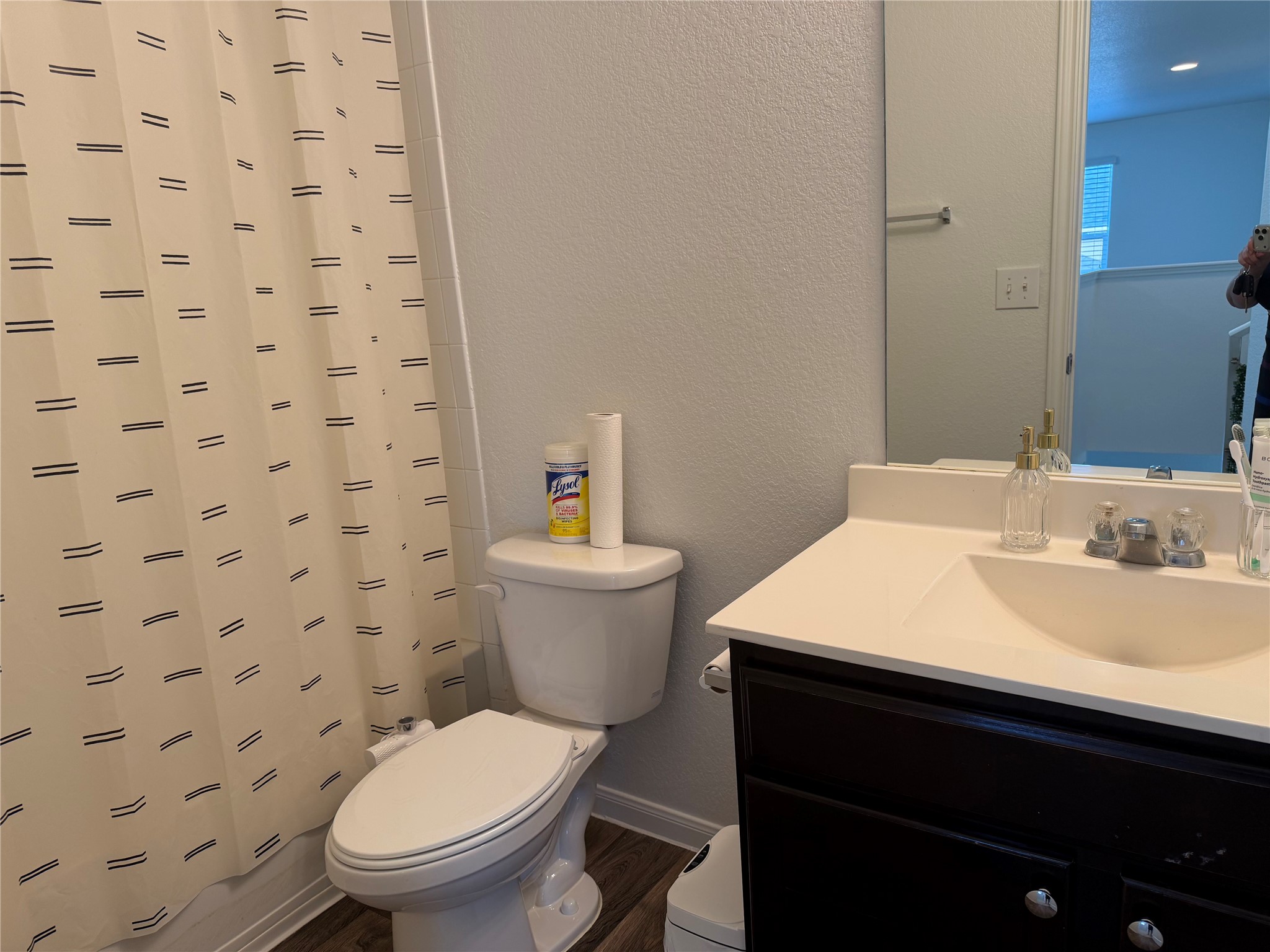 12111 Riprap Drive Manor, TX 78653 - Photo 12 of 14 a bathroom with a granite countertop toilet a sink and a mirror