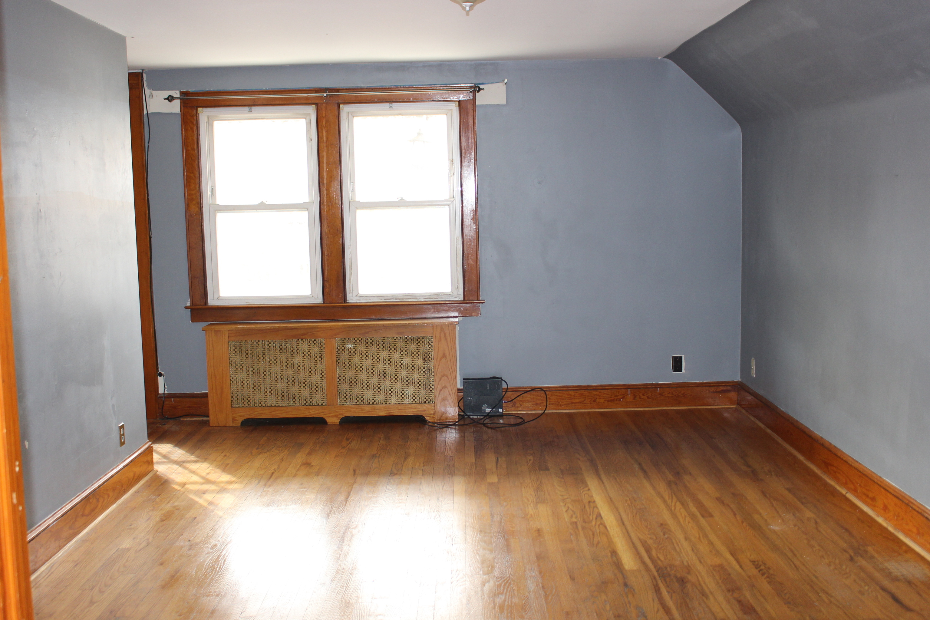 20 Merrill Street, Unit 3 Waterbury, CT 06708 - Photo 4 of 8 an empty room with wooden floor and windows