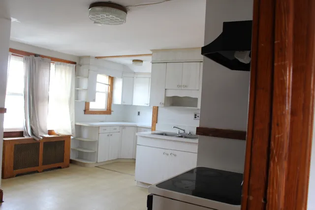 a kitchen with a sink dishwasher and a stove top oven