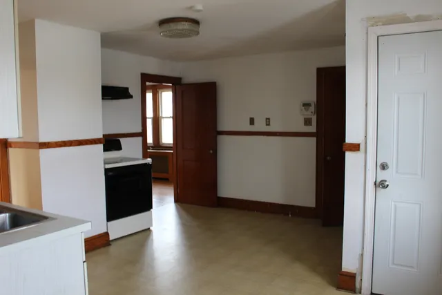 a view of a kitchen with wooden floor and electronic appliances