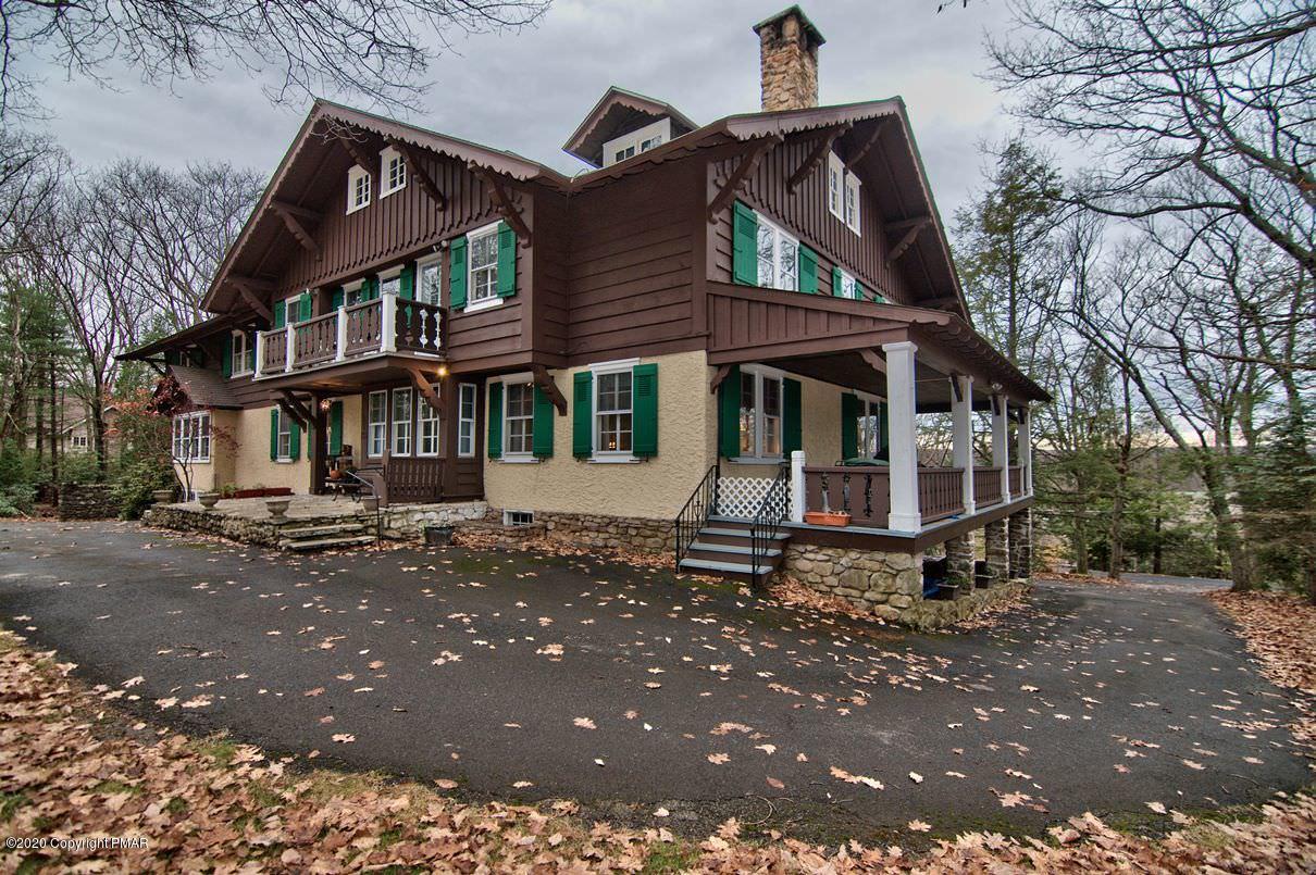 24 Summit Avenue Pocono Manor, PA 18349 - Photo 112 of 114 a view of a white house with large windows next to a road