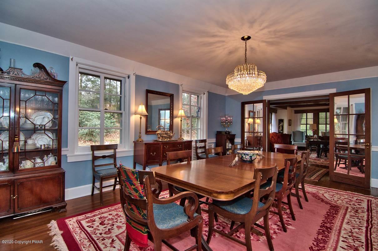 24 Summit Avenue Pocono Manor, PA 18349 - Photo 15 of 114 a dining room with wooden floor a chandelier a wooden table and chairs
