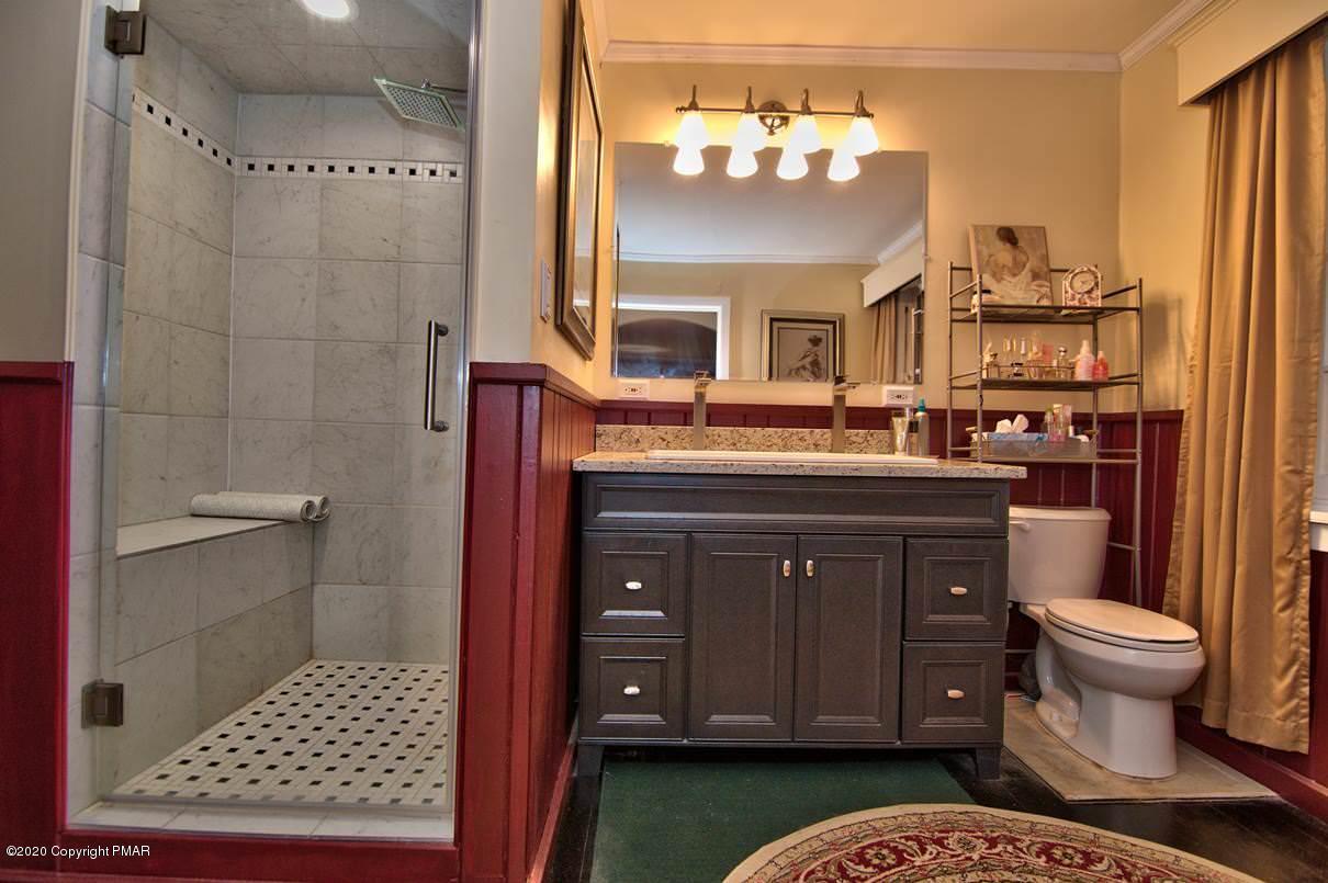 24 Summit Avenue Pocono Manor, PA 18349 - Photo 38 of 114 a bathroom with a sink a toilet and shower