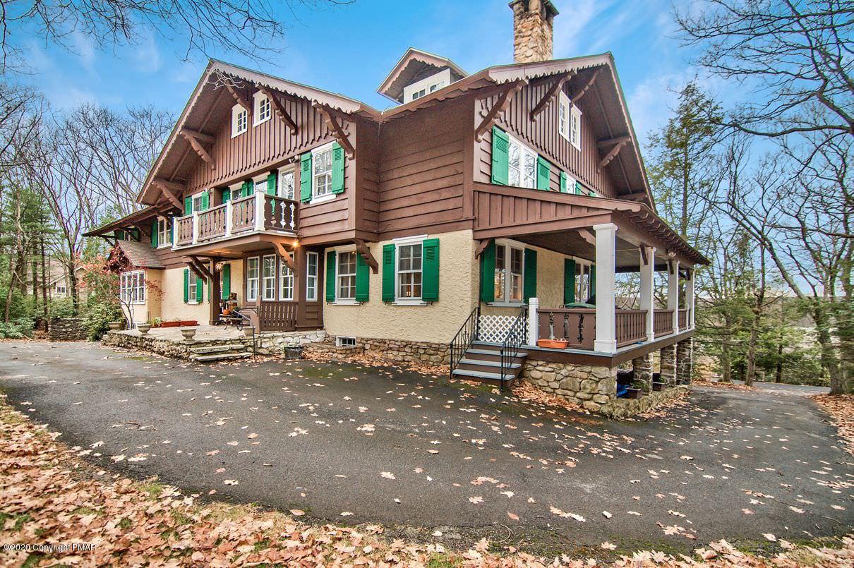 24 Summit Avenue Pocono Manor, PA 18349 - Photo 4 of 114 a view of a white house with large windows and a small yard
