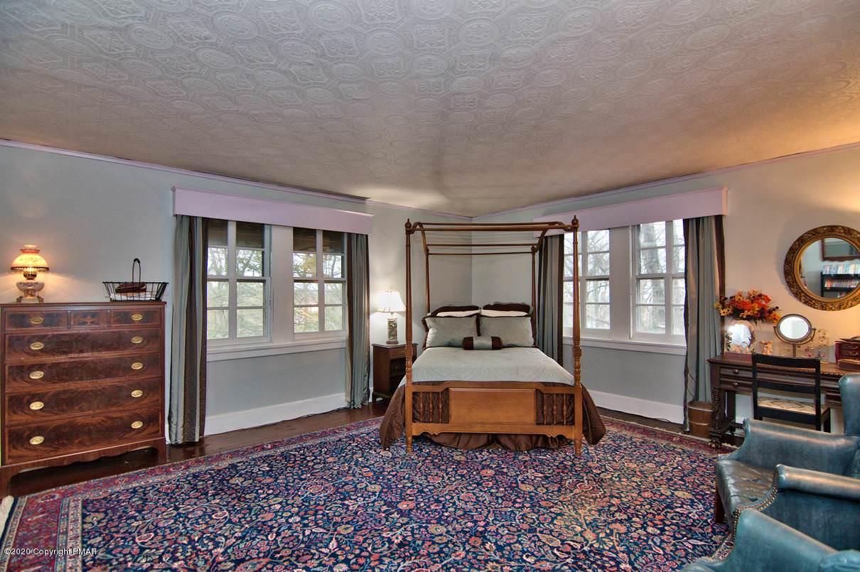24 Summit Avenue Pocono Manor, PA 18349 - Photo 42 of 114 a bedroom with a bed and wooden floor