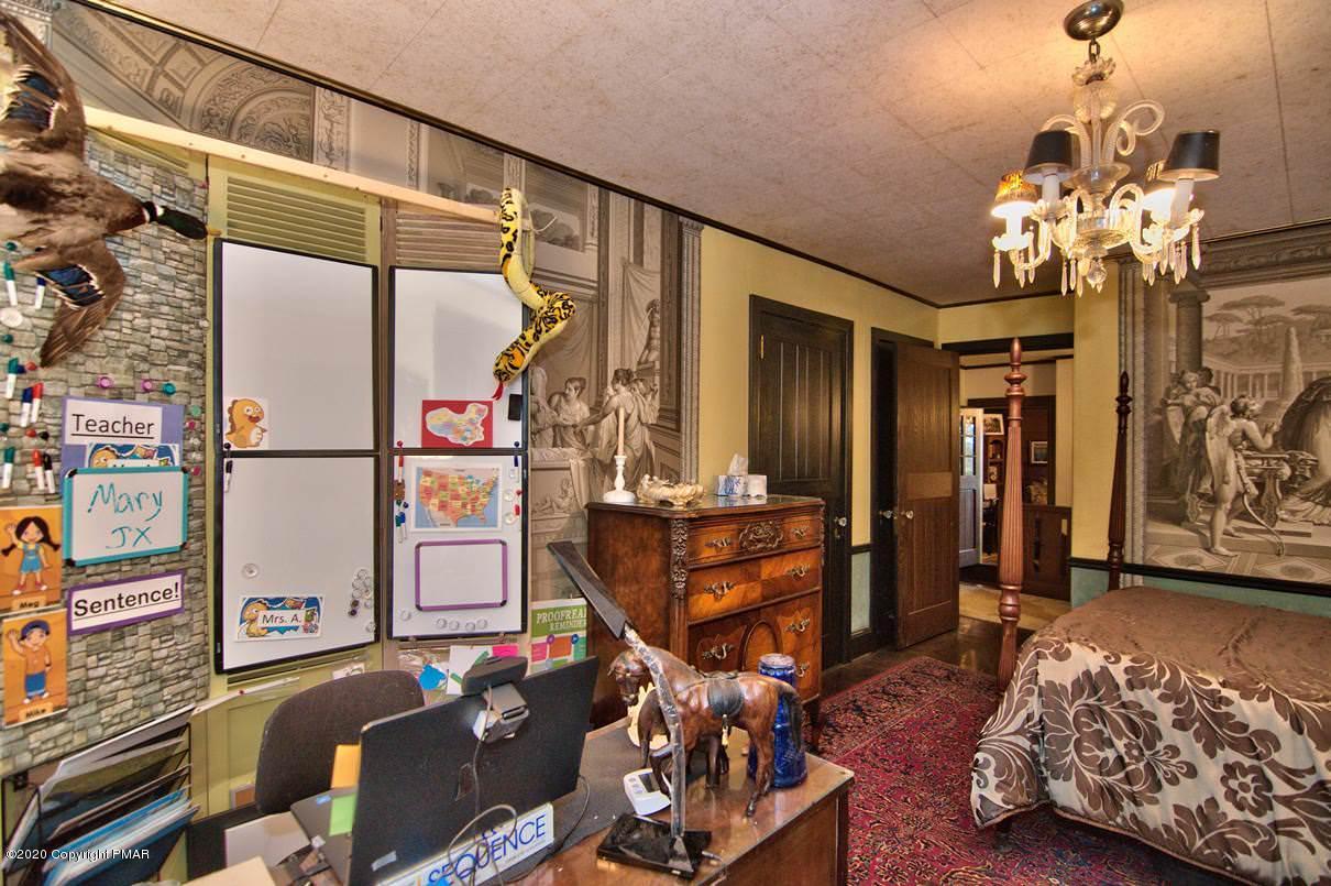 24 Summit Avenue Pocono Manor, PA 18349 - Photo 54 of 114 a bedroom with furniture and a chandelier