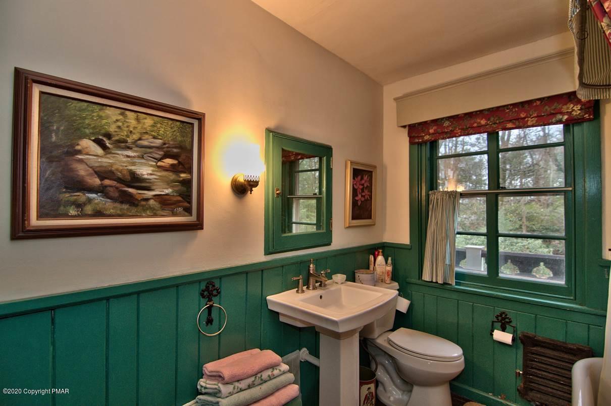 24 Summit Avenue Pocono Manor, PA 18349 - Photo 60 of 114 a bathroom with a sink mirror toilet and next to a window