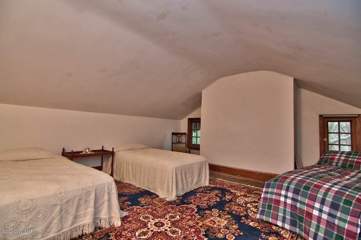24 Summit Avenue Pocono Manor, PA 18349 - Photo 84 of 114 a bedroom with two beds and painting on the wall
