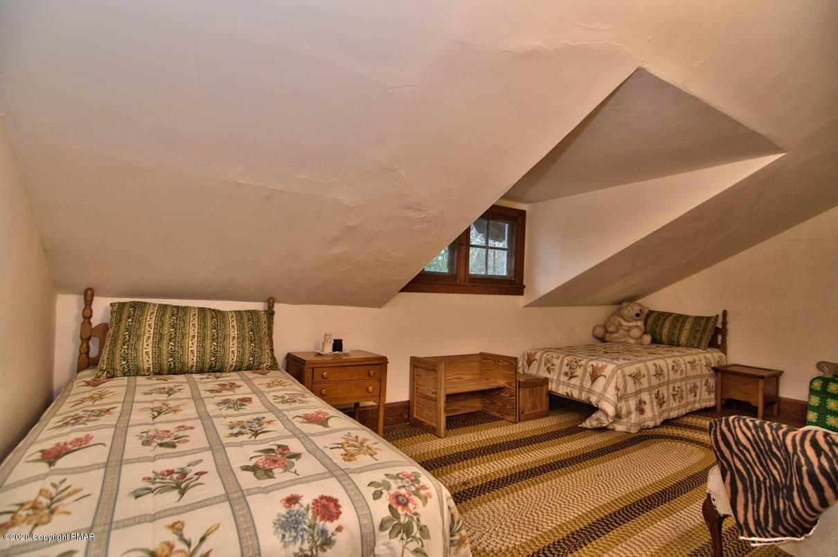 24 Summit Avenue Pocono Manor, PA 18349 - Photo 88 of 114 a bed sitting in a bedroom next to a window with two dresser