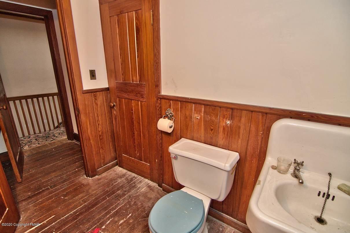 24 Summit Avenue Pocono Manor, PA 18349 - Photo 92 of 114 a white toilet sitting next to a bathroom sink