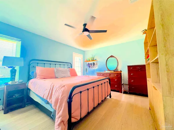a bedroom with a bed dresser and a window