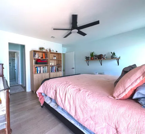a bedroom with a bed and a book shelf