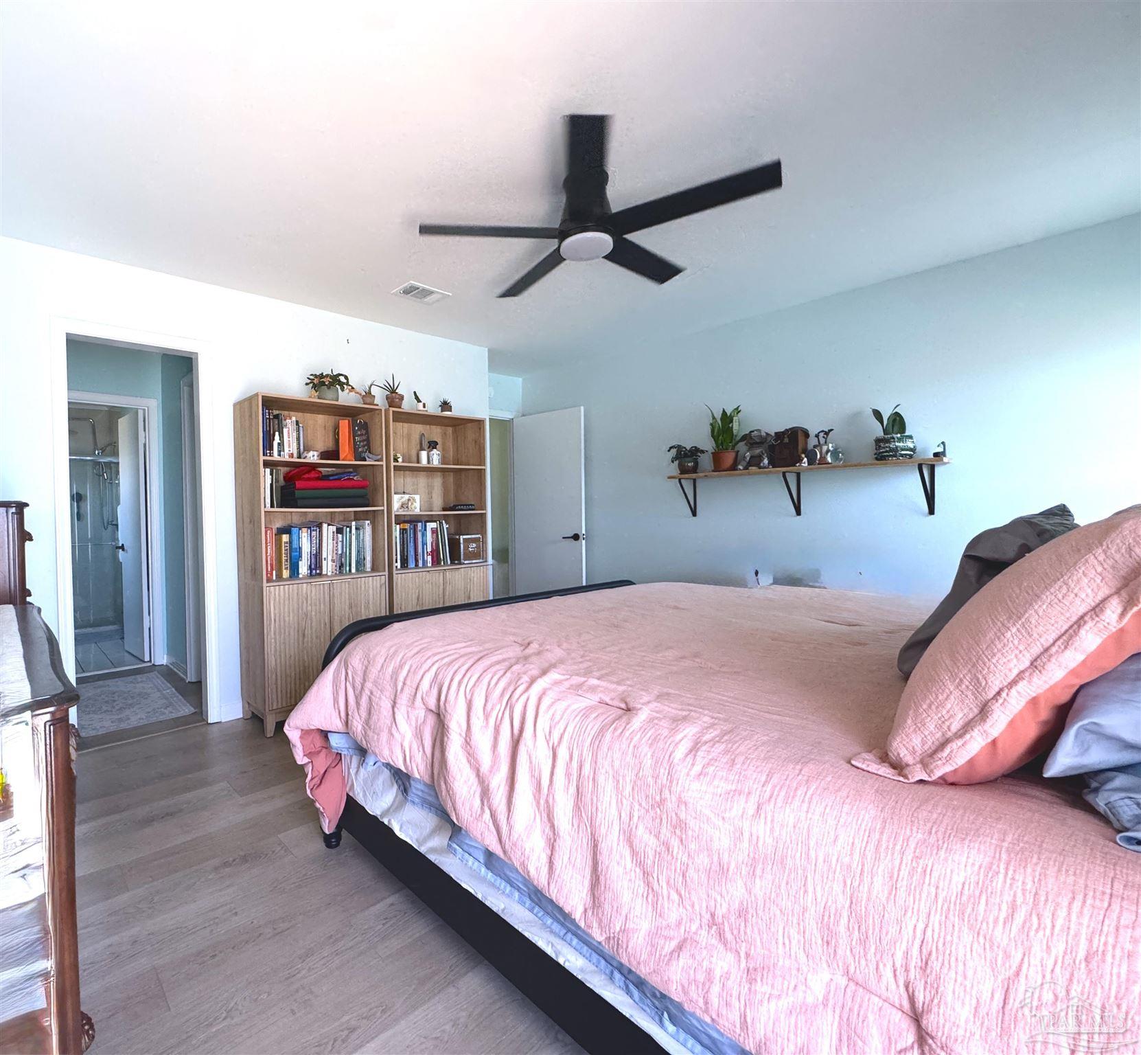 3585 Riddick Drive Pensacola, FL 32504 - Photo 12 of 22 a bedroom with a bed and a book shelf