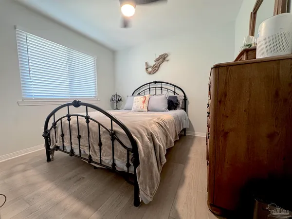 a large bed sitting in a bedroom next to a window