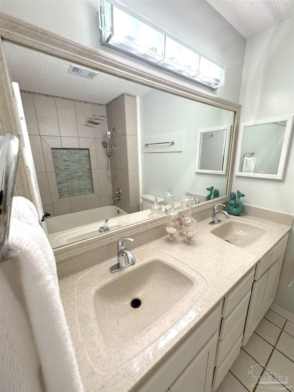 3585 Riddick Drive Pensacola, FL 32504 - Photo 16 of 22 a bathroom with a sink and a mirror