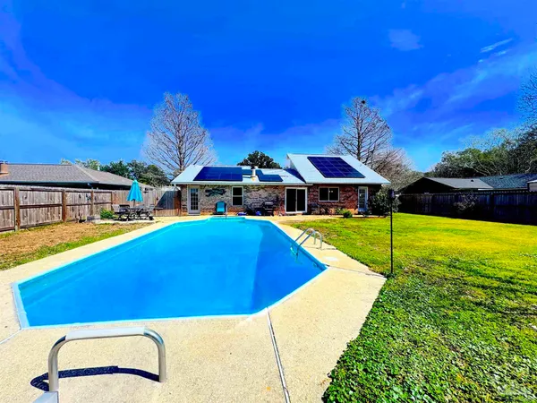 a view of an swimming pool with seating area
