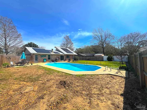 a view of a swimming pool and a yard