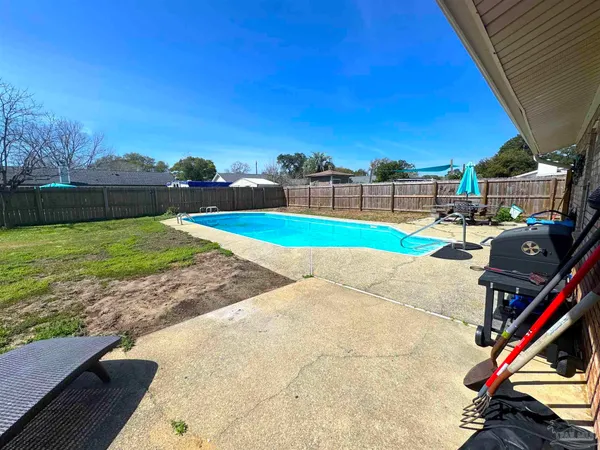 a view of a backyard and swimming pool