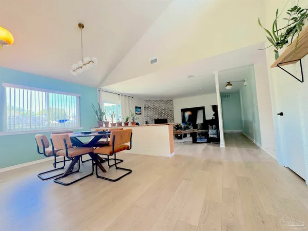 a view of a dining room with furniture and a livingroom