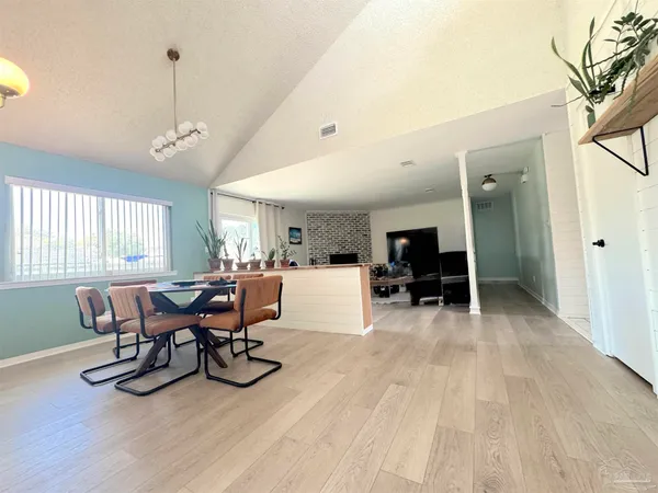 a view of a dining room with furniture window and wooden floor