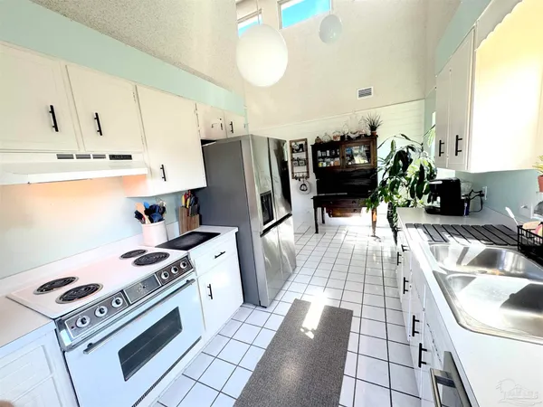 a kitchen with a sink appliances and cabinets