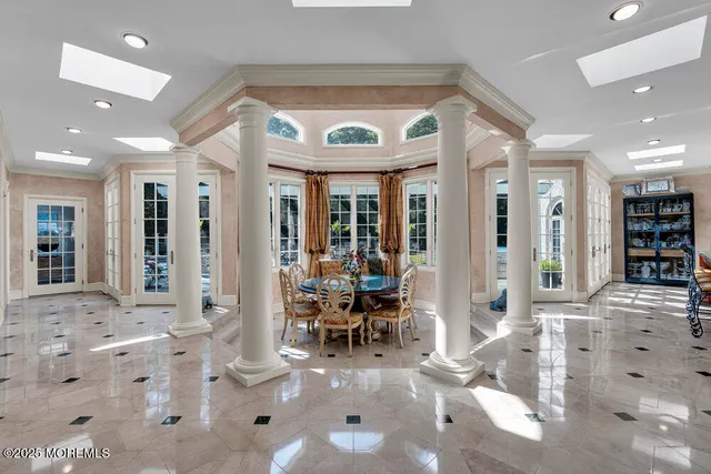 a dining room with furniture a chandelier and wooden floor