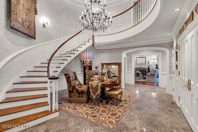 a view of a hallway with dining room and chandelier