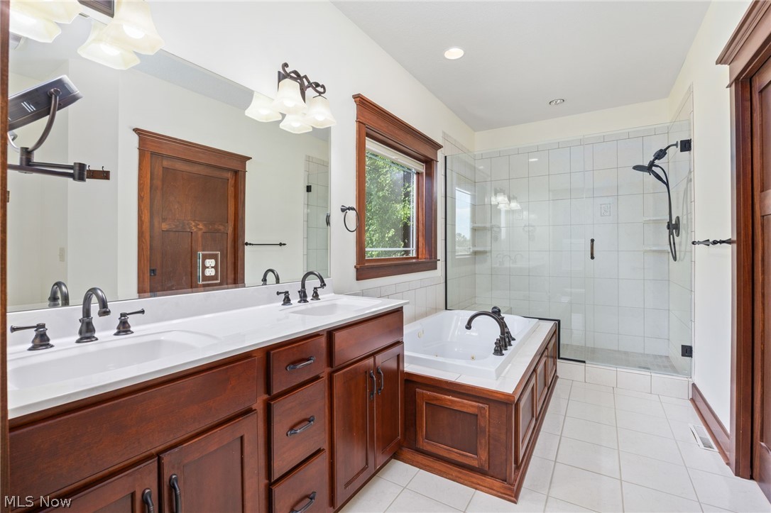 6925 River Styx Road Medina, OH 44256 - Photo 21 of 49 Bathroom featuring a dual vanity with dark wood-finish cabinetry, white countertop, and black fixtures