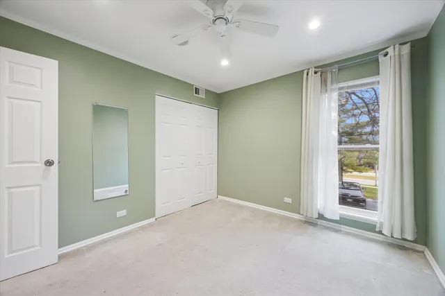 an empty room with windows and closet