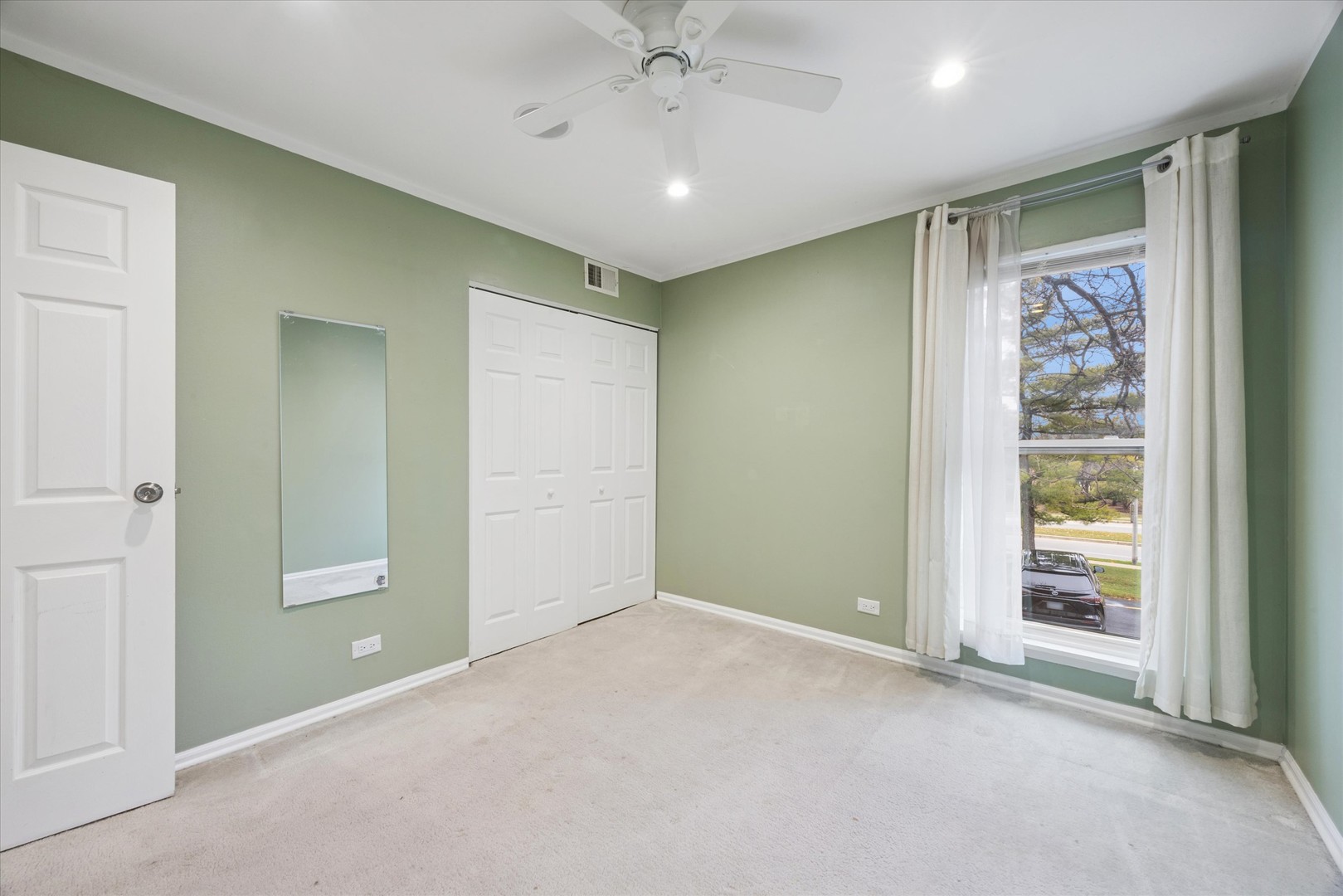 1860 Huntington Boulevard, Unit E Hoffman Estates, IL 60169 - Photo 11 of 16 an empty room with windows and closet